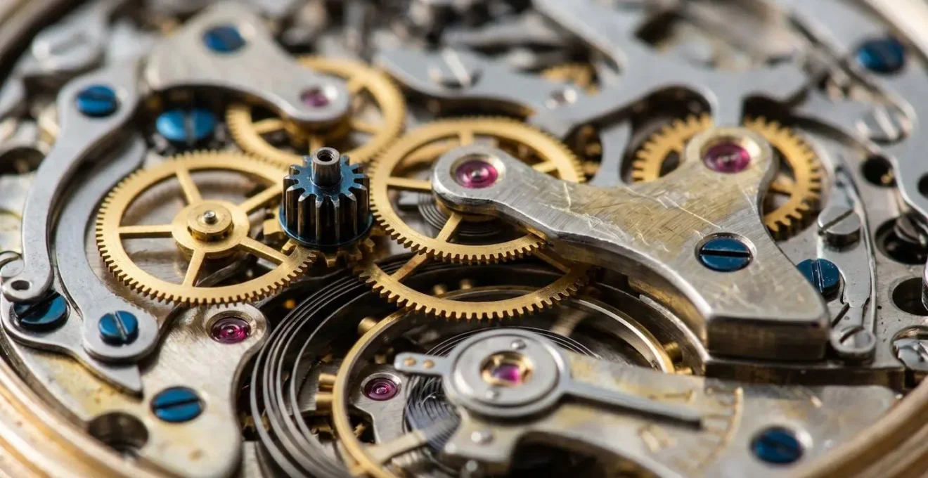 Close-up macro shot of tangled mechanical watch gears representing product complexity