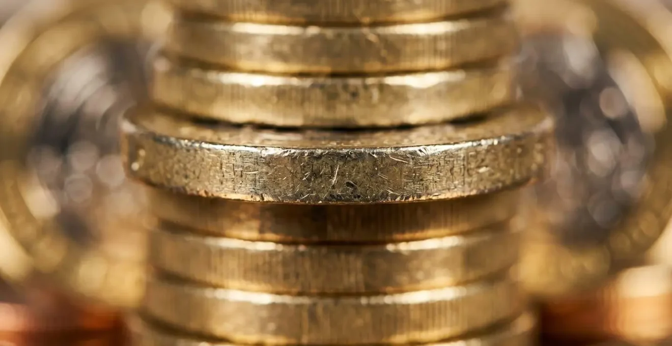 Extreme close-up of British pound coins with economic texture details